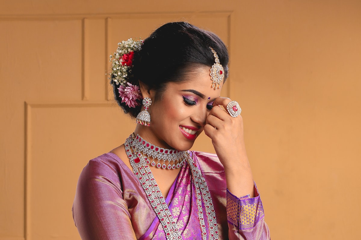 Bride in a purple pattu silk saree with jewellery — bridal wear care at AquaSpin